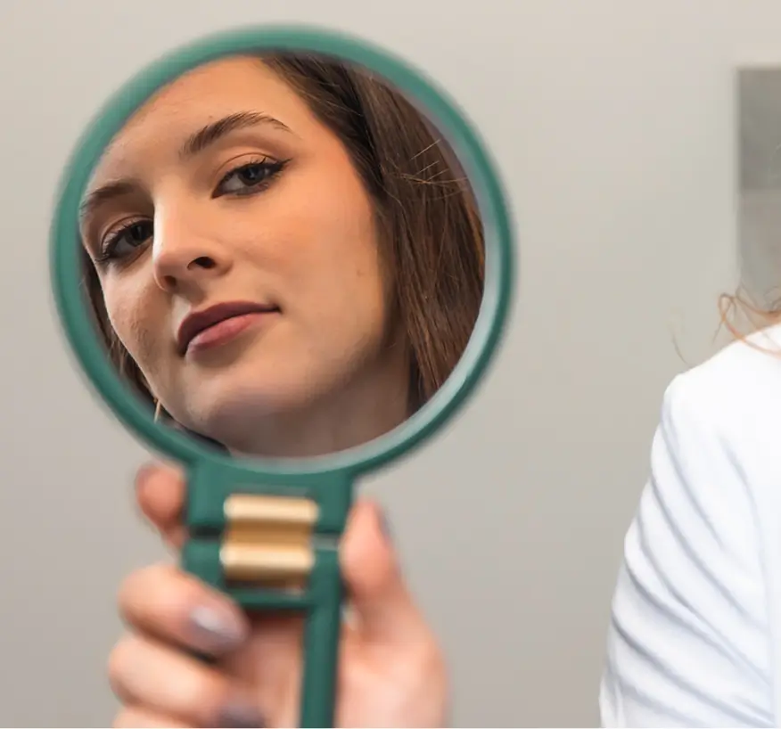 Dermatologist examining a patient's face during an acne consultation