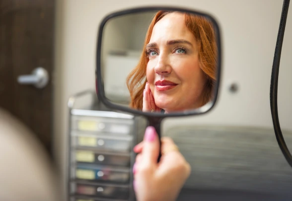 Patient smiling after subtle cheek and lip filler treatment